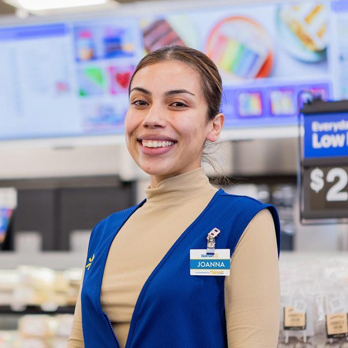 Walmart associate Joanna smiles in a Walmart store