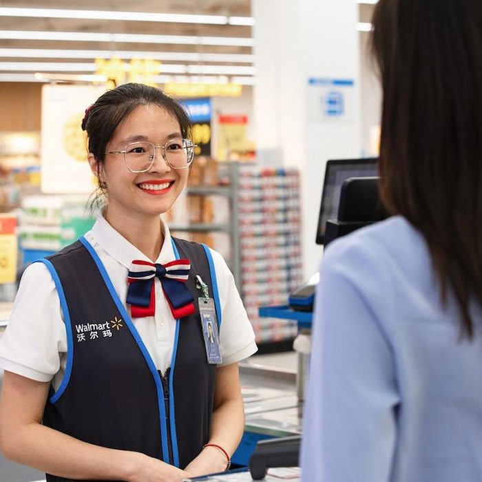 Walmart China associate smiles at a customer